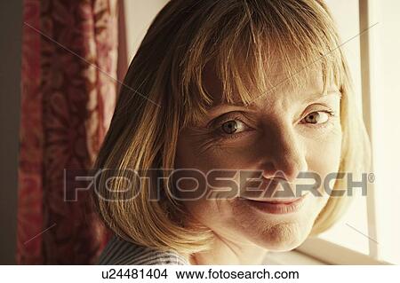 Picture - Portrait of a mature woman grinning. Fotosearch