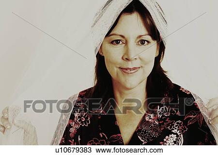 Portrait of a mature woman holding a mosquito net and smiling View Large Photo Image Stock Image - Portrait of a mature woman holding a mosquito net and smiling. Fotosearch