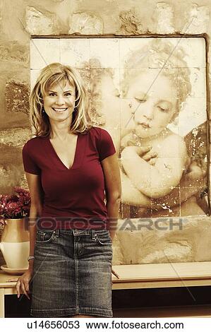 Portrait of a mature woman leaning against a table and smiling View Large Photo Image Stock Image - Portrait of a mature woman leaning against a table and smiling. Fotosearch