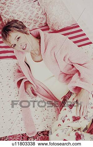 Portrait of a mature woman lying on the bed and smiling View Large Photo Image Stock Photo - Portrait of a mature woman lying on the bed and smiling. Fotosearch