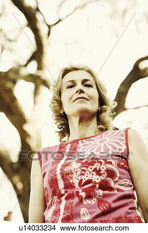 Portrait of a mature woman smiling View Large Photo Image Picture - Portrait of a mature woman smiling. Fotosearch