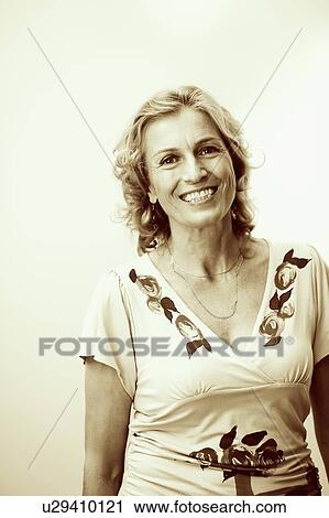 Portrait of a mature woman smiling View Large Photo Image Stock Image - Portrait of a mature woman smiling. Fotosearch