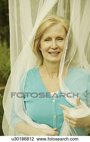 Portrait of a mature woman smiling View Large Photo Image Stock Image - Portrait of a mature woman smiling. Fotosearch