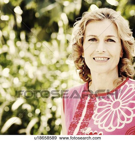 Portrait of a mature woman smiling View Large Photo Image Stock Photo - Portrait of a mature woman smiling. Fotosearch