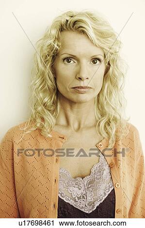 Portrait of a mid adult woman looking serious View Large Photo Image Stock Image - Portrait of a mid adult woman looking serious. Fotosearch