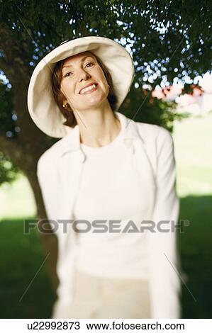 Portrait of a mid adult woman smiling View Large Photo Image Stock Image - Portrait of a mid adult woman smiling. Fotosearch