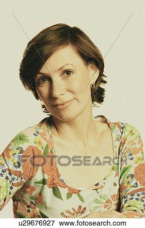 Stock Photo - Portrait of a mid adult woman smiling. Fotosearch