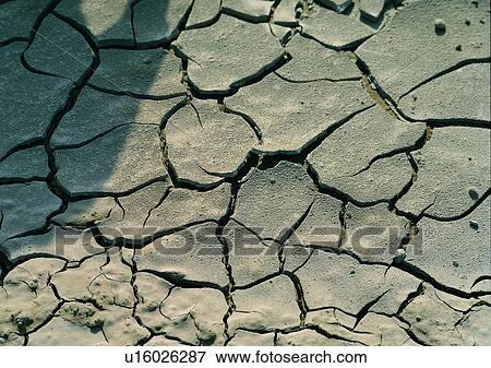 Stock Photo - crack, ground, sun light, shadow. Fotosearch