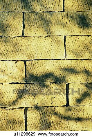 Stock Photo - shadow, sun light, wall, brick. Fotosearch
