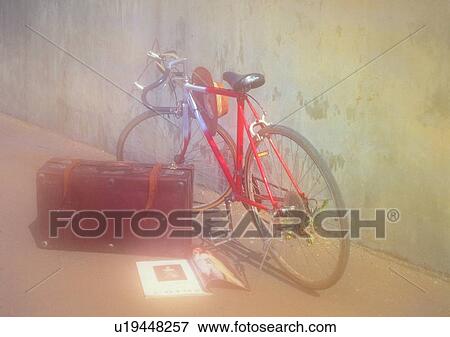 Stock Photo - bicycle, soft focus, hat, wall, flower, book. Fotosearch