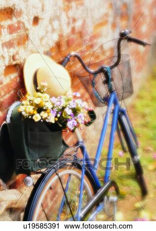 Stock Image - setting, bicycle, soft focus, hat, wall, flower. Fotosearch