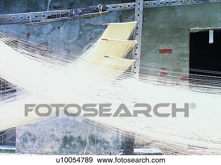Stock Photo - outdoor, wall, village, door, wood stick, noodles. Fotosearch