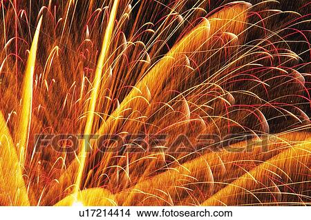 Picture -  a Part of an Orange-colored Fireworks, Exploding in the Night Sky, Low Angle View, Long Exposure. Fotosearch