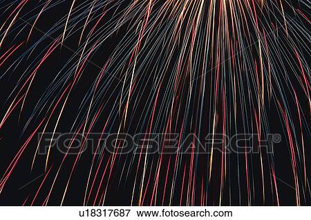 Stock Photo -  Multicolored Fine Fireworks Exploding in the Night Sky, Long Exposure, Low Angle View . Fotosearch