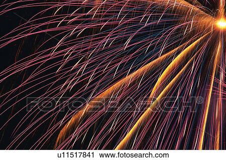 Stock Image -  Multicolored Fireworks Exploding in the Night Sky, Long Exposure, Low Angle View. Fotosearch