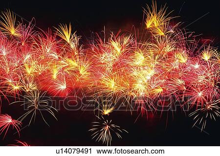 Stock Image -  Multicolored Fireworks Exploding in the Night Sky, Long Exposure, Low Angle View . Fotosearch