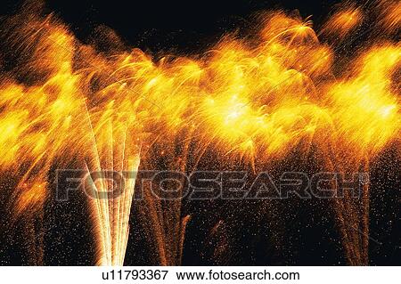 Orange-colored Firework Exploding in the Night Sky, Long Exposure, Low Angle View View Large Photo Image Stock Photo - Orange-colored Firework Exploding in the Night Sky, Long Exposure, Low Angle View. Fotosearch