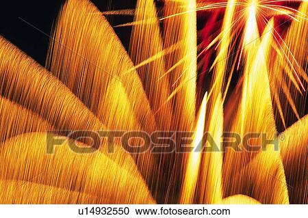Orange-colored Fireworks Exploding in the Night Sky, Long Exposure, Low Angle View View Large Photo Image Stock Image - Orange-colored Fireworks Exploding in the Night Sky, Long Exposure, Low Angle View . Fotosearch
