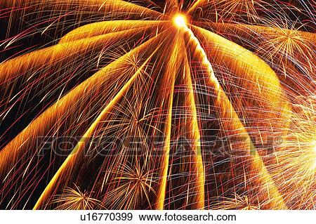 Orange-colored Fireworks Exploding in the Night Sky, Long Exposure, Low Angle View View Large Photo Image Stock Photo - Orange-colored Fireworks Exploding in the Night Sky, Long Exposure, Low Angle View. Fotosearch
