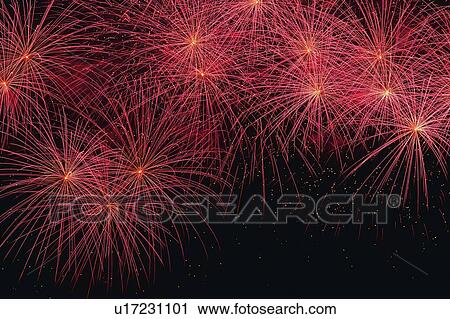 Stock Image -  Pink-colored Fireworks Exploding in the Night Sky, Long Exposure, High Angle View . Fotosearch