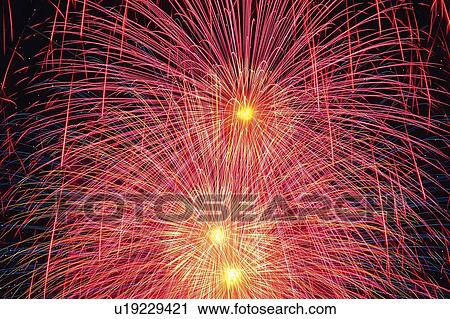Pink-colored Fireworks in the Night Sky, Long Exposure, Low Angle View View Large Photo Image Stock Image - Pink-colored Fireworks in the Night Sky, Long Exposure, Low Angle View. Fotosearch