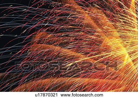 Red and Yellow-colored Fireworks Exploding in the Night Sky, Long Exposure, Low Angle View, Blurred Motion View Large Photo Image Stock Image - Red and Yellow-colored Fireworks Exploding in the Night Sky, Long Exposure, Low Angle View, Blurred Motion . Fotosearch