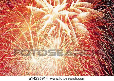 Picture -  Red-colored Fireworks Exploding in the Night Sky, Long Exposure, Low Angle View. Fotosearch