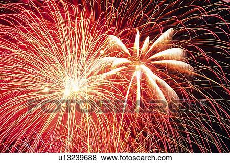 Red-colored Fireworks Exploding in the Night Sky, Long Exposure, Low Angle View View Large Photo Image Stock Photo - Red-colored Fireworks Exploding in the Night Sky, Long Exposure, Low Angle View. Fotosearch