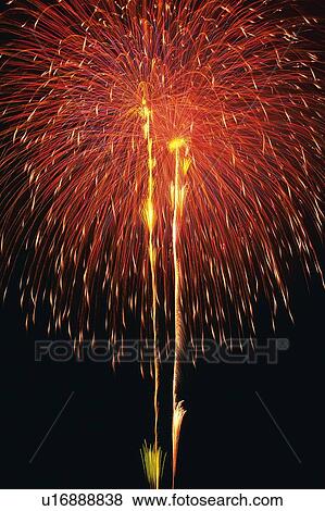 Red-colored Fireworks Exploding in the Night Sky, Long Exposure, Low Angle View View Large Photo Image Stock Photo - Red-colored Fireworks Exploding in the Night Sky, Long Exposure, Low Angle View . Fotosearch