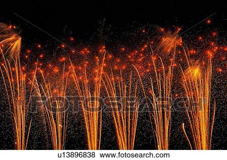 Several Fine Orange-colored Fireworks Exploding in the Night Sky, Long Exposure  View Large Photo Image Stock Photo -  Several Fine Orange-colored Fireworks Exploding in the Night Sky, Long Exposure . Fotosearch