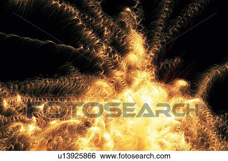 Stock Photograph -  Several Golden and Wavy Fireworks, Exploding in the Night Sky, Low Angle View, Long Exposure . Fotosearch