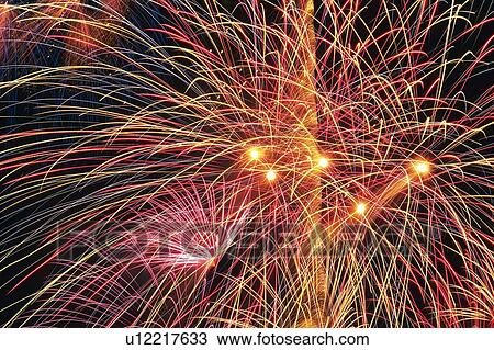 Stock Image -  Several Multicolored Fireworks Exploding in the Night Sky, Long Exposure, Low Angle View. Fotosearch