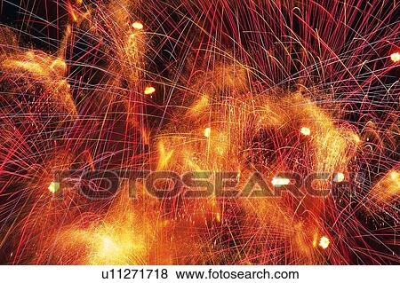 Several Red and Orange-colored Fireworks Exploding in the Night Sky, Long Exposure, Low Angle View View Large Photo Image Stock Photo - Several Red and Orange-colored Fireworks Exploding in the Night Sky, Long Exposure, Low Angle View . Fotosearch