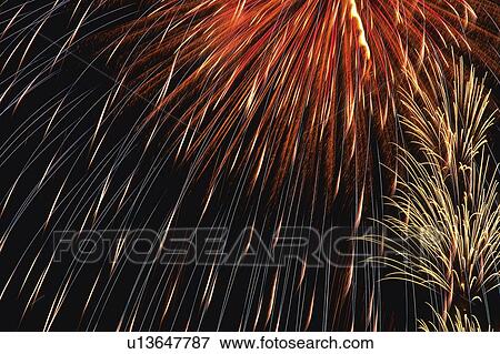 White and Red-colored Fireworks Exploding in the Night Sky, Long Exposure, Low Angle View View Large Photo Image Stock Photo - White and Red-colored Fireworks Exploding in the Night Sky, Long Exposure, Low Angle View . Fotosearch