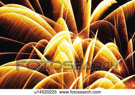 Stock Photography -  Yellow and Bronze-colored Fireworks Exploding in the Night Sky, Long Exposure, Low Angle View . Fotosearch