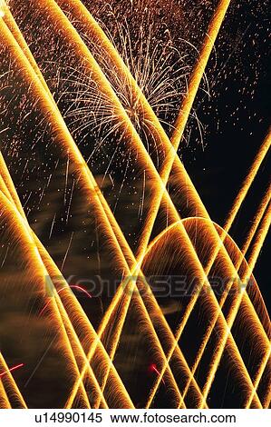 Yellow-colored Fireworks Exploding in the Night Sky, Long Exposure, Low Angle View View Large Photo Image Stock Photography - Yellow-colored Fireworks Exploding in the Night Sky, Long Exposure, Low Angle View . Fotosearch