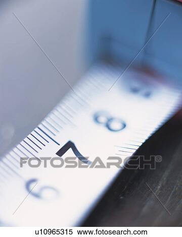Stock Photography - A tape measure, Close Up, High Angle View, Differential Focus. Fotosearch