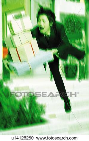 Stock Image - Young Businessman Falling With Gifts. Fotosearch