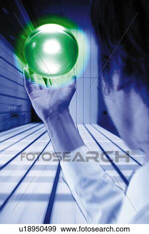 Stock Photo - Young Businessman Holding Green Ball. Fotosearch