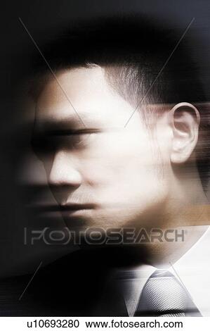 Stock Image - Young Businessman Looking Away. Fotosearch