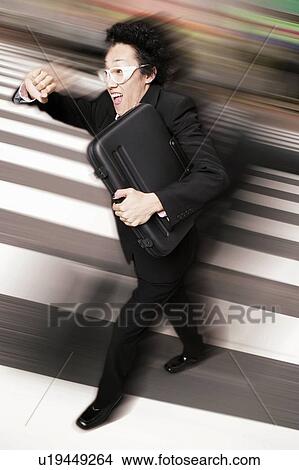Picture - Young Businessman Running. Fotosearch
