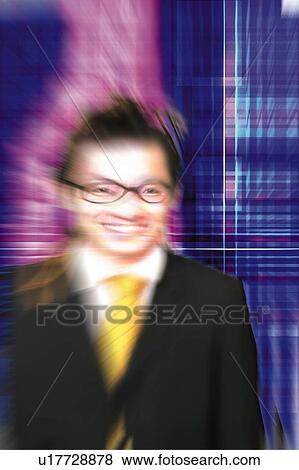 Stock Photo - Young Businessman Standing and Smiling. Fotosearch
