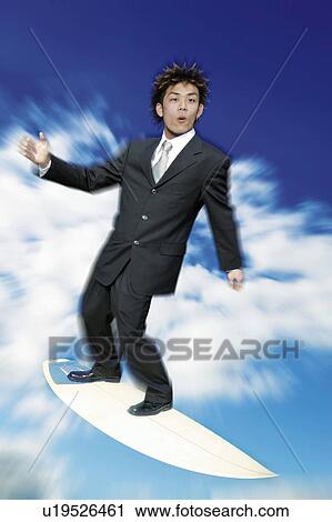Stock Image - Young Businessman Surfing. Fotosearch