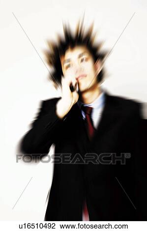 Stock Image - Young Businessman Talking On Mobile Phone. Fotosearch