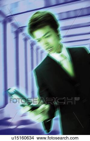 Picture - Young Businessman Using Mobile Phone. Fotosearch