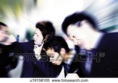 Stock Photography - Young Businessmen Talking On Mobile Phone. Fotosearch