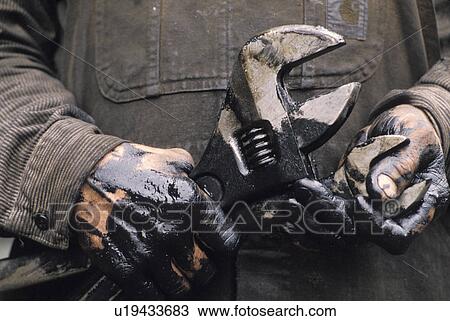Man's Oily Hands Holding Wrenches View Large Photo Image Stock Image - Man's Oily Hands Holding Wrenches. Fotosearch