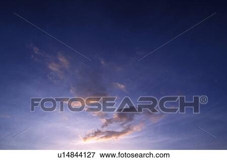 Pink Clouds In A Dark Purple Sky Stock Photo U Fotosearch