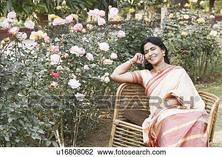 Stock Image - Portrait of a mature woman talking on a mobile phone. Fotosearch