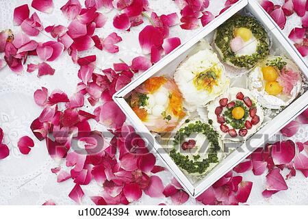 Close-up of a box of Indian sweets with flower petals around it View Large Photo Image Picture - Close-up of a box of Indian sweets with flower petals around it. Fotosearch